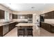 Modern kitchen with granite counters, dark wood cabinets and stainless steel appliances at 3305 Alcudia Bay Ave, Las Vegas, NV 89141