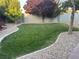 Lush backyard featuring mature trees and meticulous rock landscaping at 3365 Badura Ave, Las Vegas, NV 89118