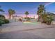 Inviting backyard pool with a fireplace and lush palm trees, perfect for outdoor relaxation at 3365 Badura Ave, Las Vegas, NV 89118