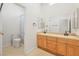 Bathroom featuring tile floors, double sinks, and separate toilet and shower area at 3365 Badura Ave, Las Vegas, NV 89118