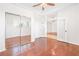 Bright bedroom with wood floors, mirrored closet doors, and white trim at 3365 Badura Ave, Las Vegas, NV 89118