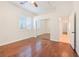 Bedroom featuring hardwood floors, a sliding-door closet, and plantation shutters at 3365 Badura Ave, Las Vegas, NV 89118