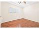 Bedroom featuring hardwood floors, plantation shutters, and neutral paint at 3365 Badura Ave, Las Vegas, NV 89118