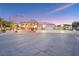 Well-lit house at dusk, showcasing landscaped front yard, large driveway, and a three-car garage at 3365 Badura Ave, Las Vegas, NV 89118