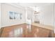Sunlit living room featuring hardwood floors and white plantation shutters at 3365 Badura Ave, Las Vegas, NV 89118
