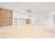 Spacious living area with fireplace, stone wall detail and tile flooring at 3365 Badura Ave, Las Vegas, NV 89118