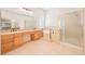 Elegant main bathroom with double vanity, soaking tub, shower, and plantation shutters at 3365 Badura Ave, Las Vegas, NV 89118