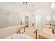 Bright main bathroom featuring a soaking tub, shower, dual sinks, and large mirrors at 3365 Badura Ave, Las Vegas, NV 89118