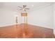 Spacious main bedroom with hardwood floors, ceiling fan, and view to en suite at 3365 Badura Ave, Las Vegas, NV 89118