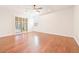 Bright main bedroom featuring hardwood floors, ceiling fan, and sliding glass door at 3365 Badura Ave, Las Vegas, NV 89118