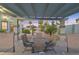 Inviting outdoor dining area under a pergola, overlooking the pool and beautifully landscaped backyard at 3365 Badura Ave, Las Vegas, NV 89118