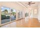 Spacious sunroom with hardwood floors and expansive views of the backyard and pool at 3365 Badura Ave, Las Vegas, NV 89118
