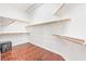 Walk-in closet featuring hardwood floors, custom shelving, and ample storage space at 3365 Badura Ave, Las Vegas, NV 89118