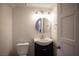 Cozy bathroom featuring a modern vanity, a round mirror, and updated lighting at 3369 Milenko Dr, Las Vegas, NV 89121