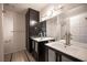 Modern bathroom featuring dual sinks, tile floor, and a walk-in shower at 3369 Milenko Dr, Las Vegas, NV 89121