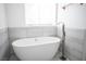Stunning bathroom features a sleek soaking tub with modern fixtures and a large window at 3369 Milenko Dr, Las Vegas, NV 89121