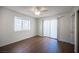 Bedroom with ceiling fan, wood floors, and sliding glass door to a patio at 3369 Milenko Dr, Las Vegas, NV 89121