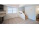 Bright dining room with a window and stairs to the upper level of the home at 3369 Milenko Dr, Las Vegas, NV 89121