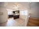 Bright kitchen featuring dark wood cabinetry, stainless steel appliances, and adjacent breakfast nook with stairs at 3369 Milenko Dr, Las Vegas, NV 89121