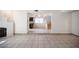 Open-concept living area with tile flooring, fireplace, stairs, and a view into the kitchen at 3369 Milenko Dr, Las Vegas, NV 89121