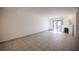 Open living room with tiled floors, fireplace, and sliding door access to patio at 3369 Milenko Dr, Las Vegas, NV 89121