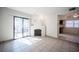 Inviting living area boasts tile floors, a modern fireplace, a sliding glass door, and a glimpse of the kitchen at 3369 Milenko Dr, Las Vegas, NV 89121