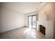 Bright living room with tiled floors, fireplace, and sliding door access to patio at 3369 Milenko Dr, Las Vegas, NV 89121