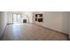 Open living room features tile flooring, a modern fireplace, and a view of the kitchen at 3369 Milenko Dr, Las Vegas, NV 89121