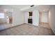 Open living area with tile flooring, fireplace, stairs, wet bar, and a door at 3369 Milenko Dr, Las Vegas, NV 89121