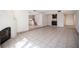 Expansive living room featuring tile floors, a modern fireplace, stairs, and a wet bar at 3369 Milenko Dr, Las Vegas, NV 89121