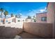 Private outdoor patio with desert landscape, showcasing community buildings and a vibrant blue sky at 3369 Milenko Dr, Las Vegas, NV 89121
