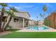 View of the backyard with a private pool, covered patio, and lush landscaping at 3588 Franciscan Ln, Las Vegas, NV 89121