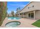 Relax in the backyard with a pool, spa and patio surrounded by lush landscaping at 3588 Franciscan Ln, Las Vegas, NV 89121