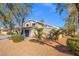 Inviting two-story home with blue garage doors and desert landscaping at 3588 Franciscan Ln, Las Vegas, NV 89121