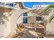 Charming front entryway with a unique arched pergola and blue double doors at 3588 Franciscan Ln, Las Vegas, NV 89121
