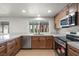 Well-lit kitchen featuring stainless steel appliances, wood cabinets, and a large window at 3588 Franciscan Ln, Las Vegas, NV 89121