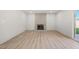 Spacious living room features hardwood floors and brick fireplace at 3588 Franciscan Ln, Las Vegas, NV 89121
