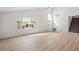Bright living room with light wood floors, a modern chandelier and view to front courtyard at 3588 Franciscan Ln, Las Vegas, NV 89121