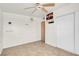 This cozy bedroom features tile flooring and a ceiling fan at 3709 Perliter Ave, North Las Vegas, NV 89030