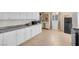 Updated kitchen features stainless steel appliances, white cabinets, and tiled floors at 3709 Perliter Ave, North Las Vegas, NV 89030