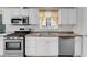 Close up of the stainless steel oven, dishwasher, and granite countertop in the kitchen at 3709 Perliter Ave, North Las Vegas, NV 89030
