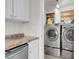 Convenient laundry room with modern washer and dryer, plus extra storage at 3709 Perliter Ave, North Las Vegas, NV 89030