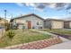Cozy house featuring a well-kept lawn and garden with a charming walkway leading to the front door at 4102 Calimesa St, Las Vegas, NV 89115