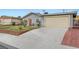 Street view of a one-story house with a large concrete driveway leading to an attached garage at 4102 Calimesa St, Las Vegas, NV 89115