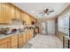 Well-lit kitchen with light wooden cabinetry, stainless steel appliances, and tiled flooring at 4102 Calimesa St, Las Vegas, NV 89115
