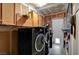 Laundry room with cabinets and black washing and drying machine at 4102 Calimesa St, Las Vegas, NV 89115