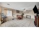 Bright living room with tiled floor, ceiling fan, and a dining table with four chairs at 4102 Calimesa St, Las Vegas, NV 89115