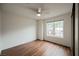 A bright bedroom with a ceiling fan, wood-look floors, and a large window at 430 Nancy Dr, Henderson, NV 89015