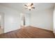 Bright bedroom featuring wood-look floors, ceiling fan, and ensuite bath at 430 Nancy Dr, Henderson, NV 89015