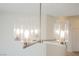Close-up of a modern chandelier featuring brushed nickel and five clear glass shades at 430 Nancy Dr, Henderson, NV 89015